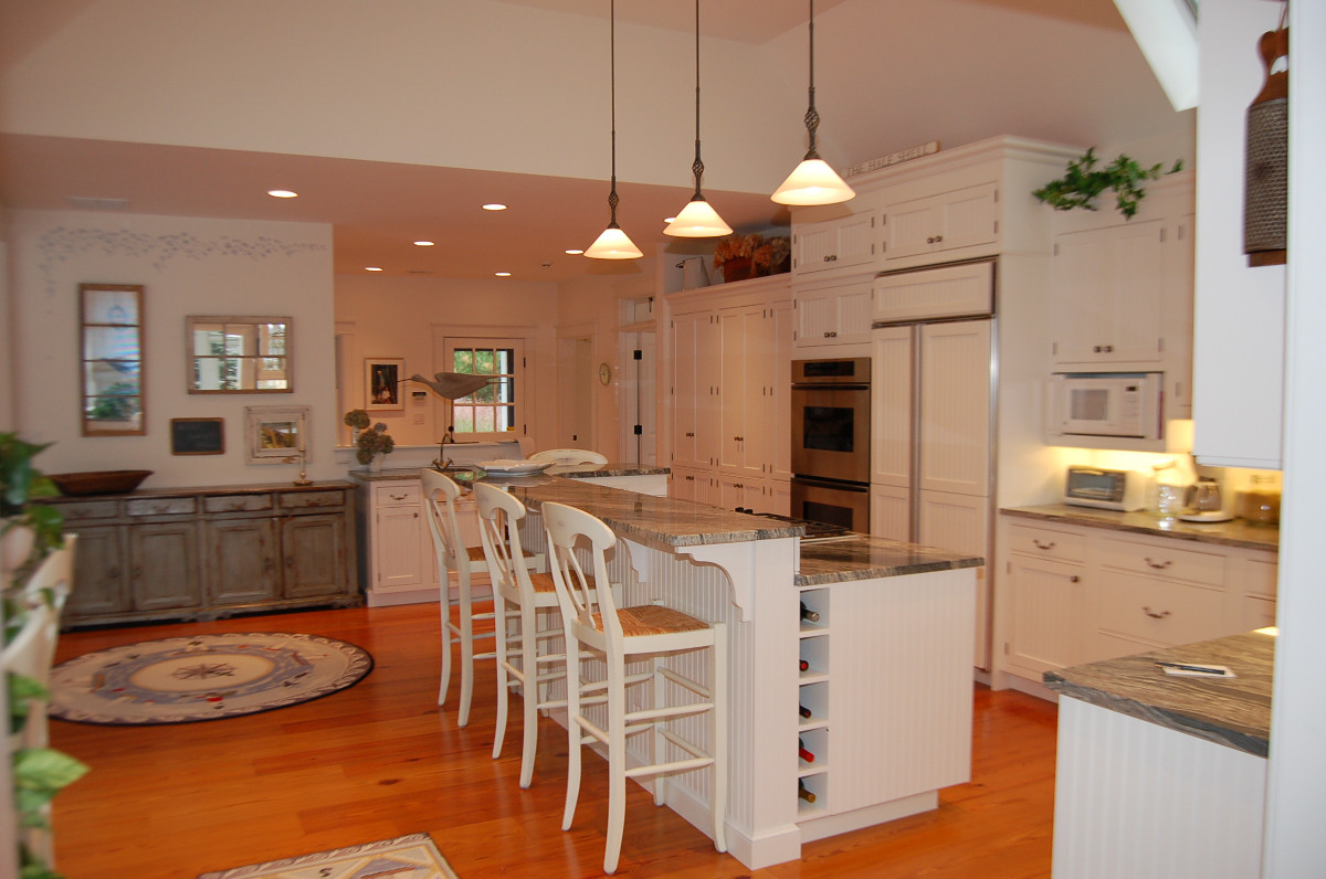 Remodeled kitchen with hardwood floors and marbel-top island