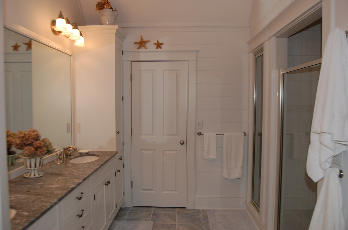 Master bathroom with stone tile floor and double marble vanity