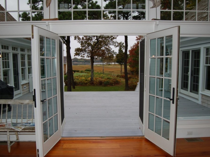Patio doors and full-size windows opened to outside deck and golf course beyond